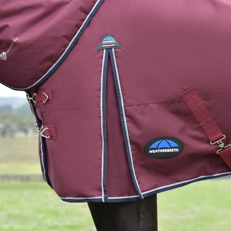 Weatherbeeta Comfitec Essential 220g rug in Burgundy/Navy on a horse outdoors on grass.