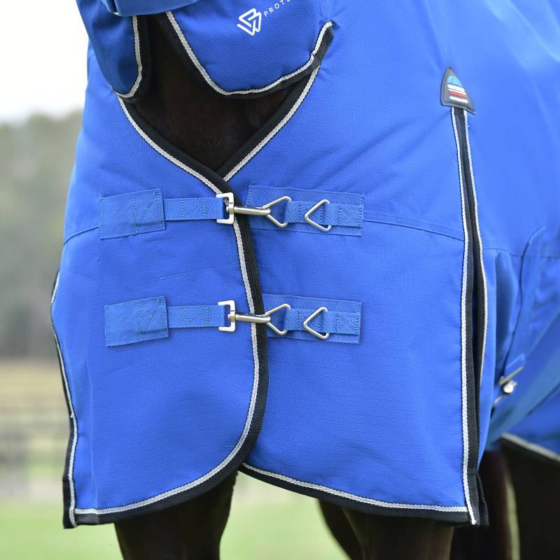 Weatherbeeta Comfitec Essential 220g cobalt/black turnout rug on a dark horse outdoors.