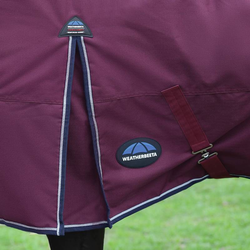Close-up of a burgundy/navy Weatherbeeta Comfitec Essential 220g turnout rug on a horse outdoors.
