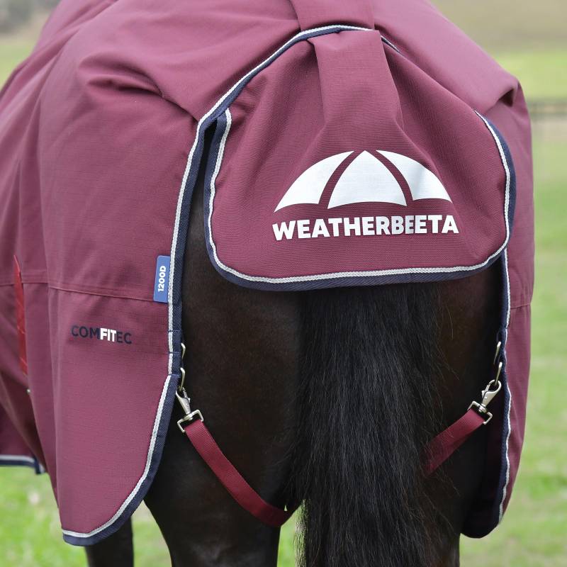 A horse wearing a burgundy/navy Weatherbeeta Comfitec Essential Std Neck Turnout Rug 220g.