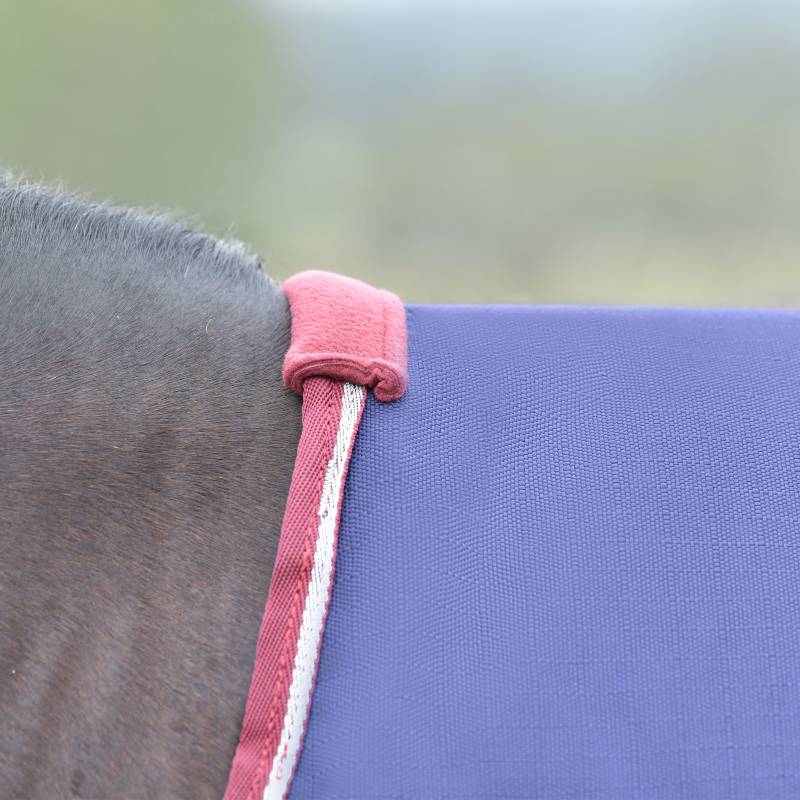 Close-up of a purple pad with maroon/white trim under Weatherbeeta Comfitec Essential Turnout.