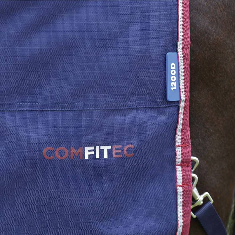Close-up of a navy Weatherbeeta Comfitec Essential Turnout Rug with burgundy trim.