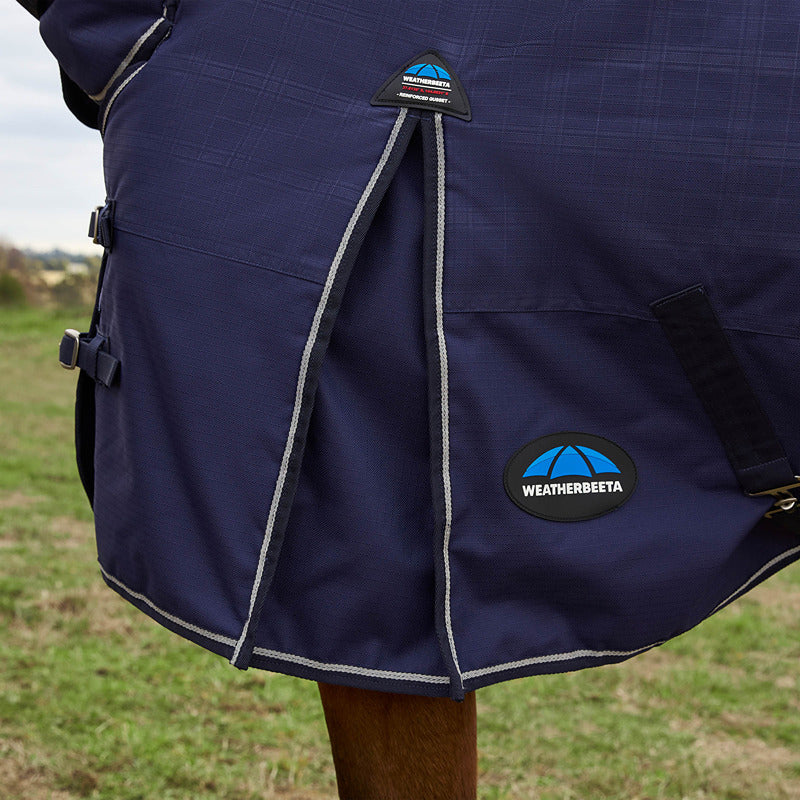 Weatherbeeta Comfitec Prelim Combo Neck 0G Navy turnout rug on horse, grass background.