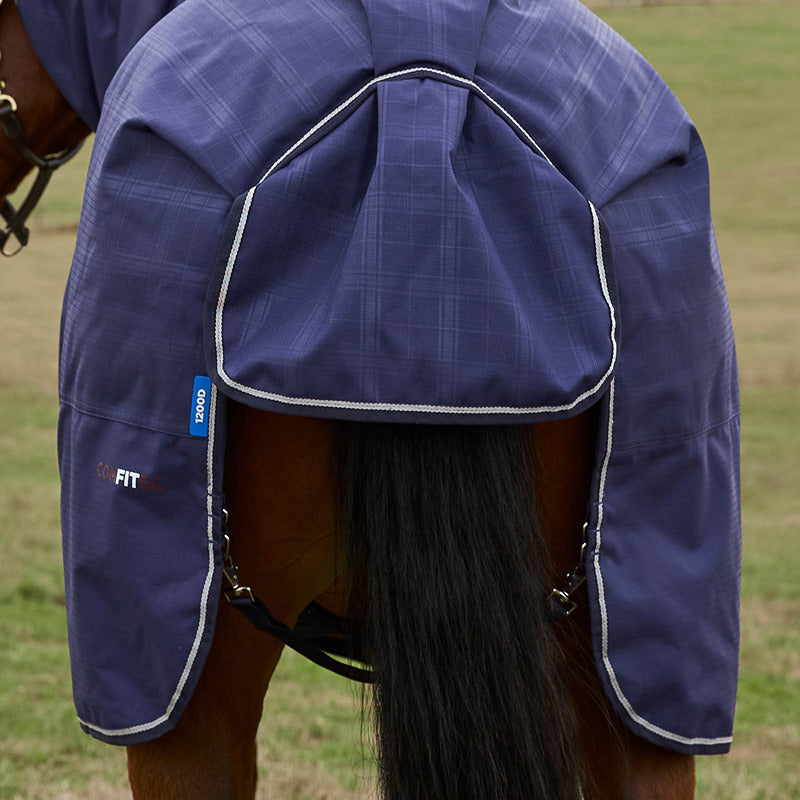 A horse in a Weatherbeeta Comfitec Prelim Combo Neck Turnout Rug in a grassy field.