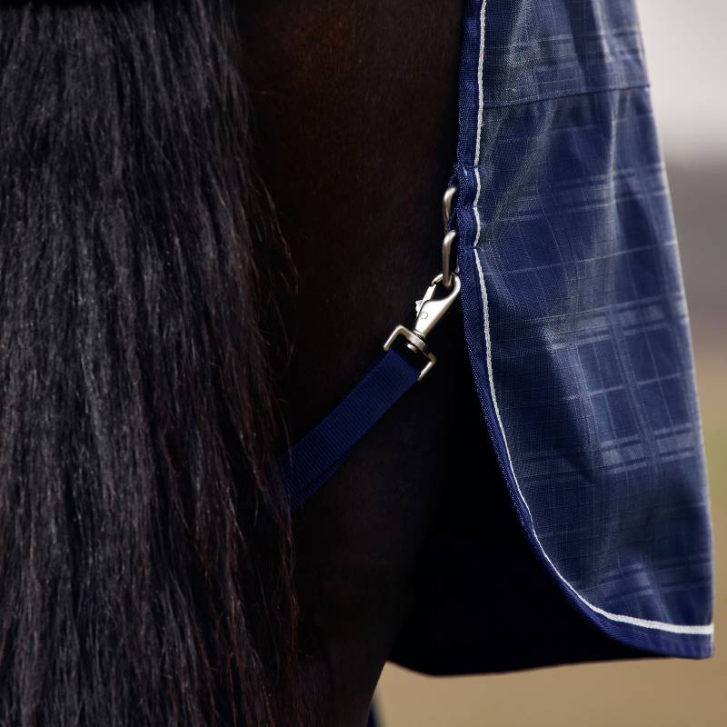 Close-up of a horse in a Weatherbeeta Comfitec Prelim 220g Navy Embossed Plaid Turnout Rug.