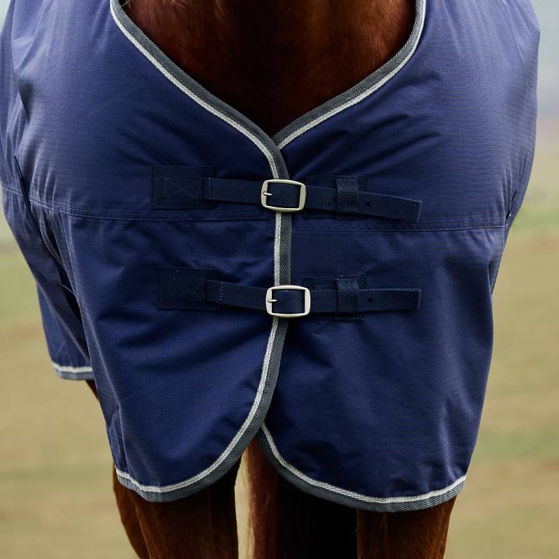 Weatherbeeta Comfitec Tyro Turnout Rug 220g in navy/charcoal on horse, featuring chest buckles.