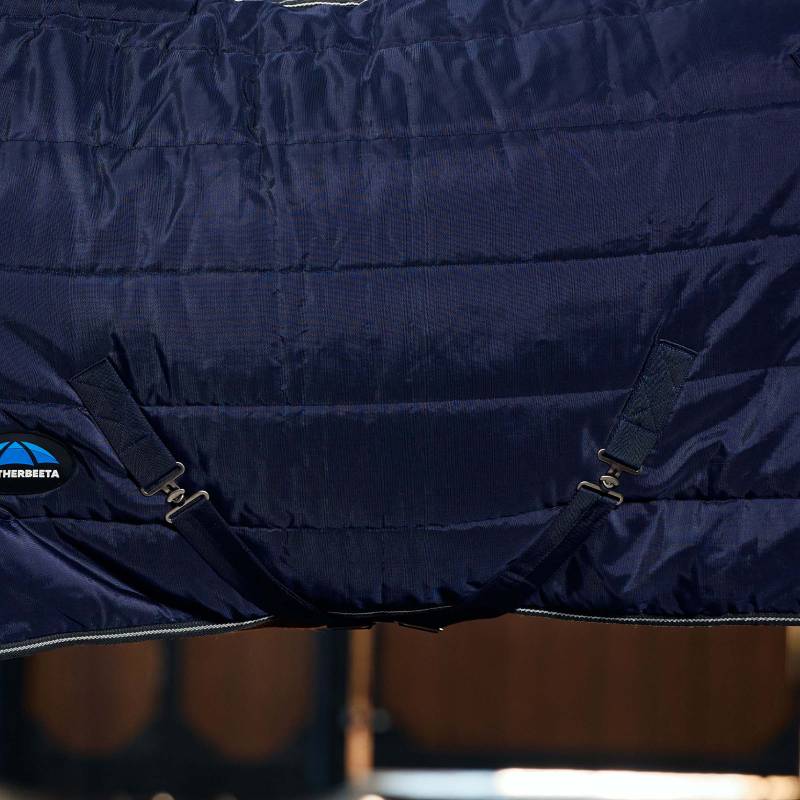 Close-up of Weatherbeeta Comfitec PP Channel Quilt Stable Rug in navy/charcoal with straps.