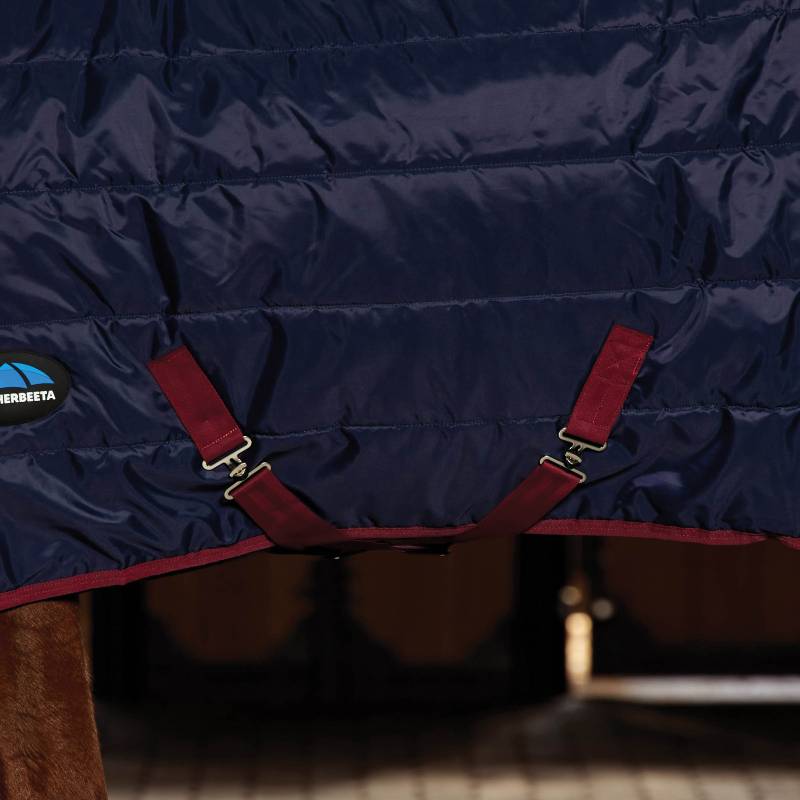 Close-up of Weatherbeeta ComFitec 210D Channel Quilt Stable Rug Navy/Burgundy with logo shown.