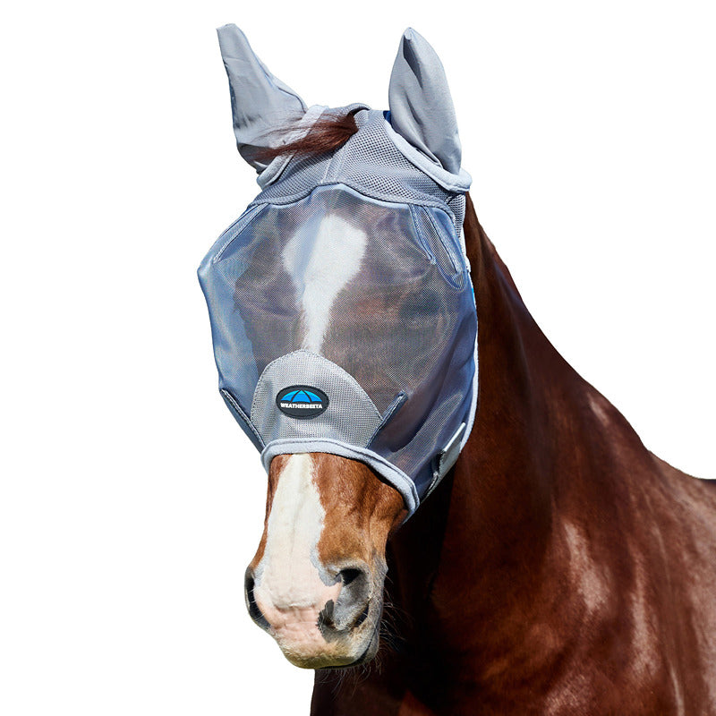 A horse outdoors wears a Weatherbeeta Comfitec Fine Mesh Fly Mask With Ears in grey.