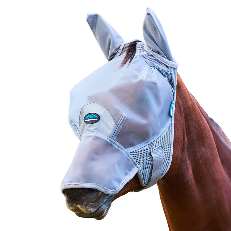 A horse outdoors in a Weatherbeeta grey fine mesh fly mask with ear and nose covers.