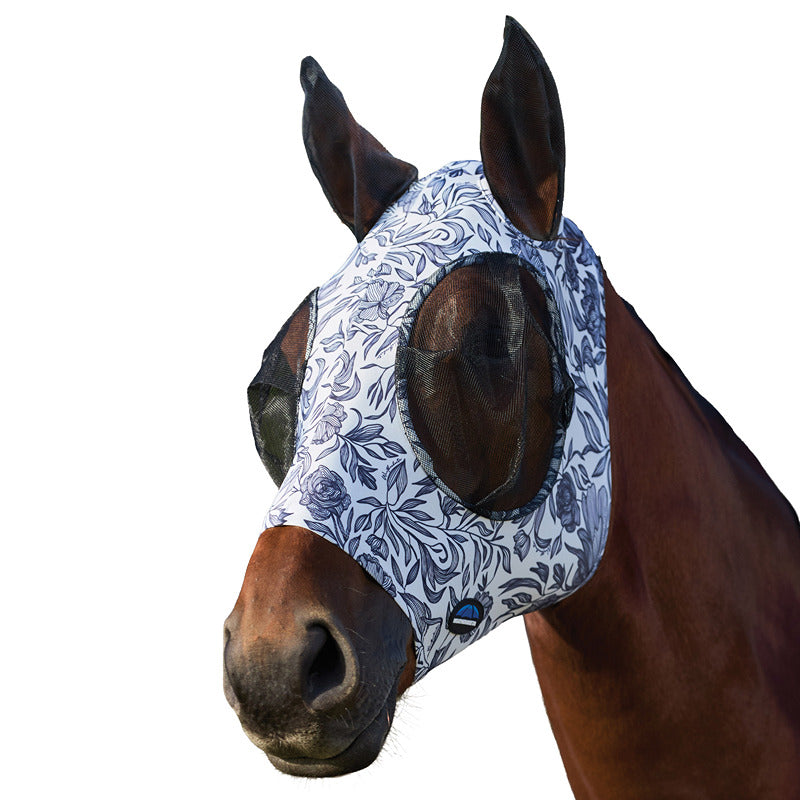 A horse wears a Weatherbeeta floral fly mask with ears for UV protection outdoors.