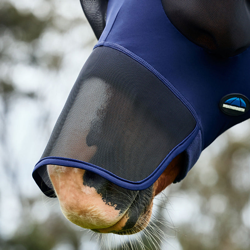 Closeup of a horse outdoors wearing a Weatherbeeta Comfitec Luxe Stretch Fly Mask Navy/Black.