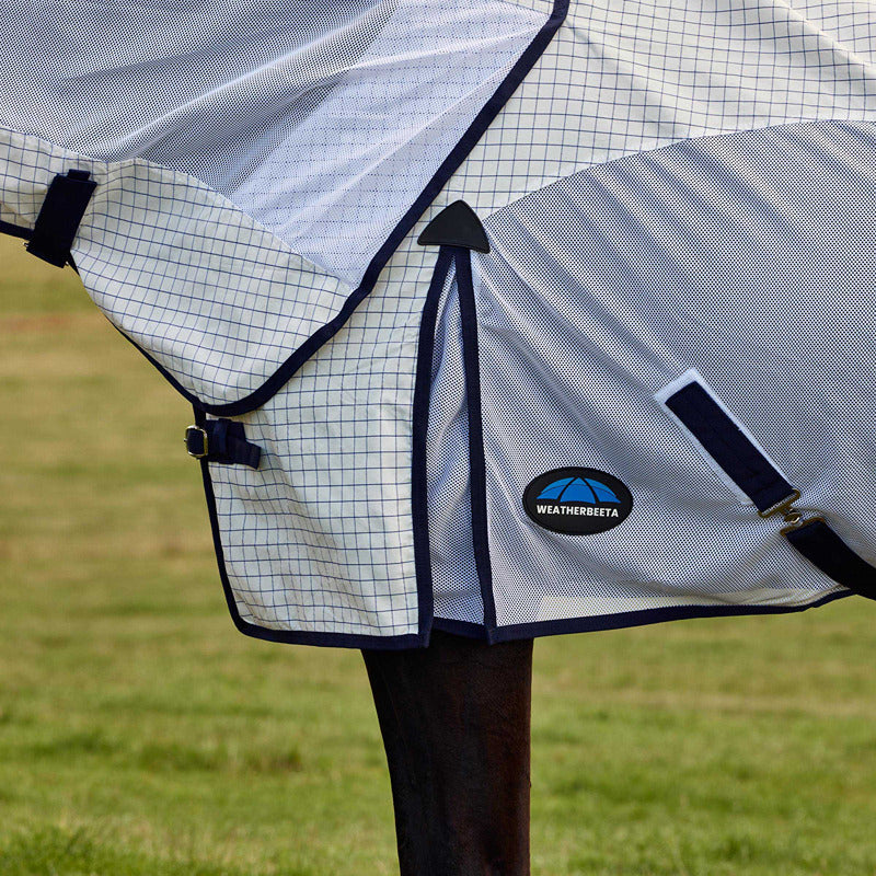 Horse wearing a Weatherbeeta Airstream Lightweight Rug in White/Navy, standing on grass.