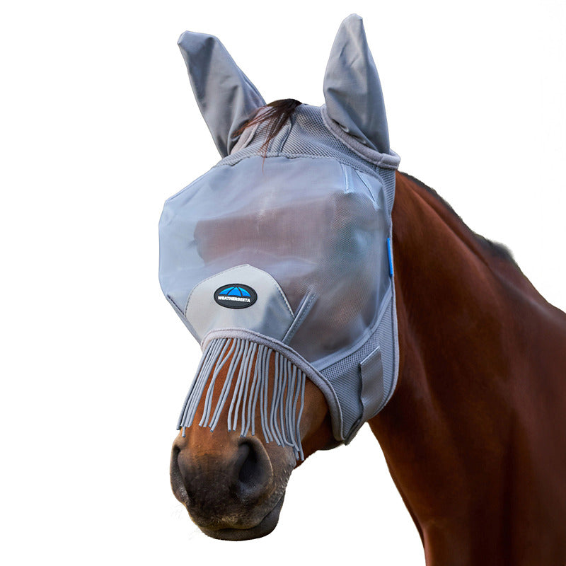 A horse wears a Weatherbeeta Comfitec Fine Mesh Fly Mask With Ears & Tassels in grey.