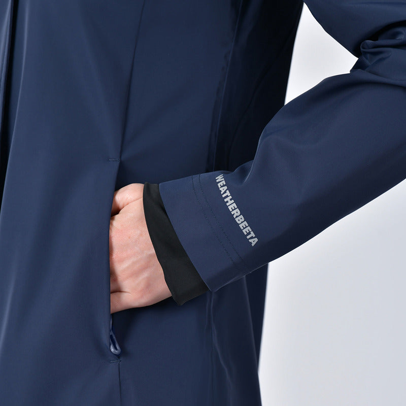 Close-up of a hand in pocket on the Weatherbeeta Protect Waterproof Longline Riding Jacket Navy.