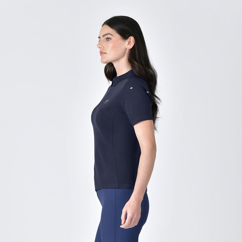 Woman wearing a Weatherbeeta 37.5 navy performance polo with UV protection stands against white.