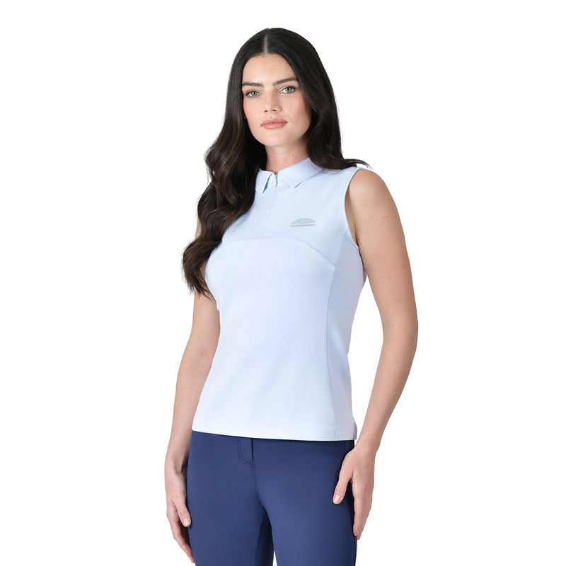 Woman in a Weatherbeeta 37.5 Sleeveless Performance Polo Mist Blue and navy pants on white.
