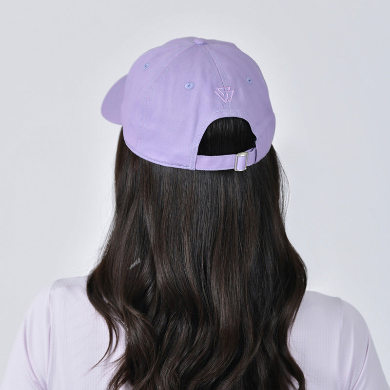 Woman in a Weatherbeeta Performance Cotton Cap in Lavender Mist facing the camera.