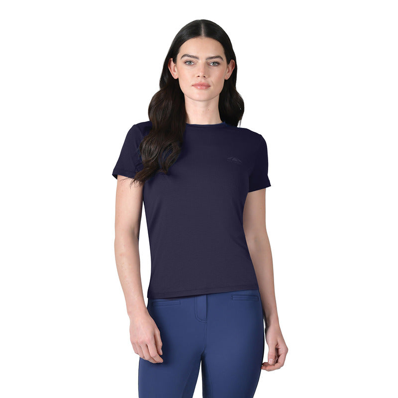 Woman with long dark hair in Weatherbeeta Relaxed Copper UV Tee Navy, blue pants, white background.