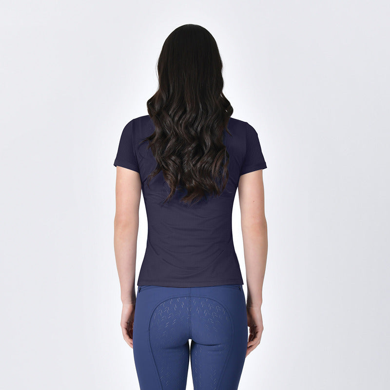Woman with long dark hair in Weatherbeeta Relaxed Copper UV Tee Navy, blue pants, white background.