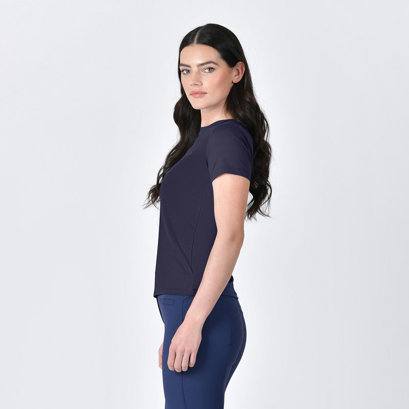 Woman with long dark hair in Weatherbeeta Relaxed Copper UV Tee Navy stands sideways.