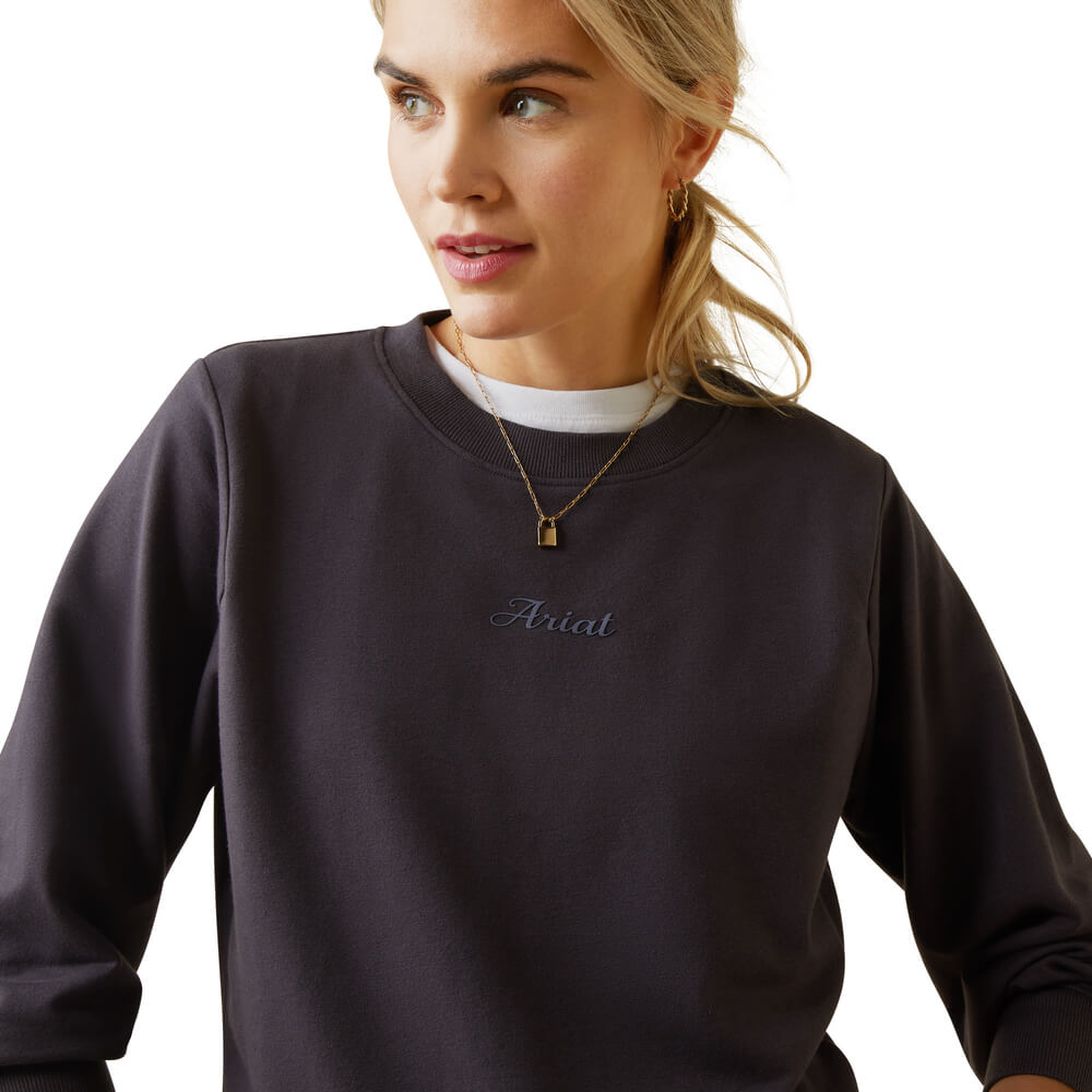 Woman in an Ariat Womens Memento Sweatshirt Periscope and gold jewelry, looking sideways.