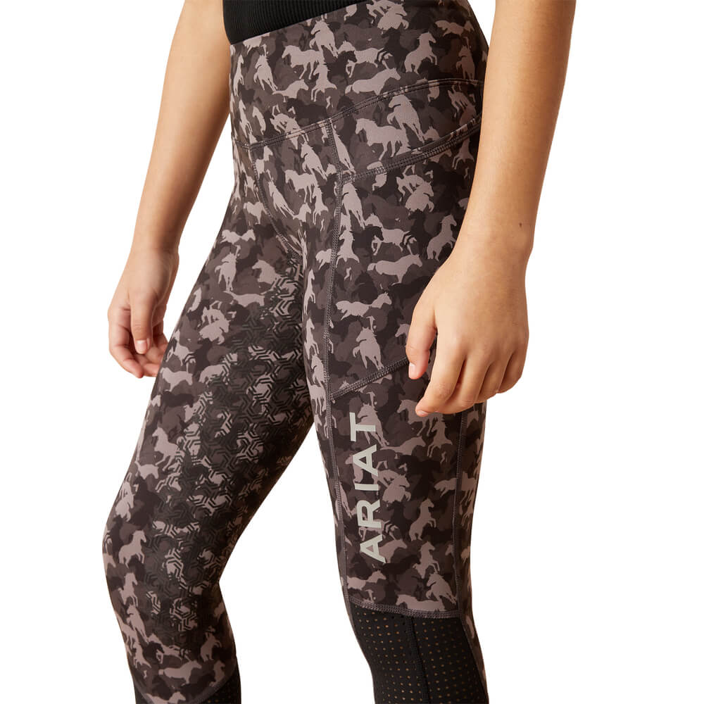 Wearing Ariat Youth Eos Full Seat Tight Periscope Camo Horse leggings with full seat grip.