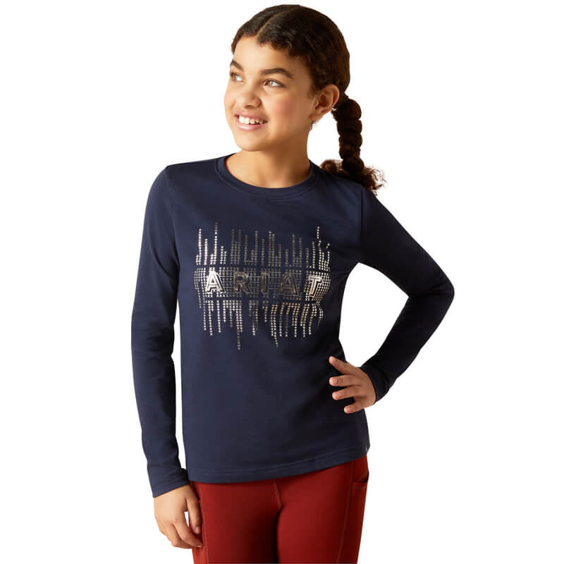 Smiling girl in an Ariat Youth Glitz Long Sleeve Top Navy Eclipse with front decorative lines.