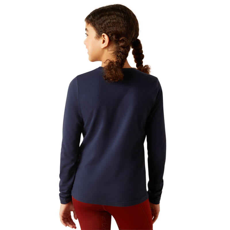 Girl with curly braided hair wears the Ariat Youth Glitz Long Sleeve Top in Navy Eclipse, facing away.