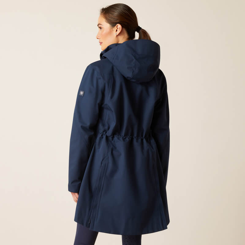 Woman in Ariat Womens Coastal Long H2O Parka Navy, seen from the back against a plain background.