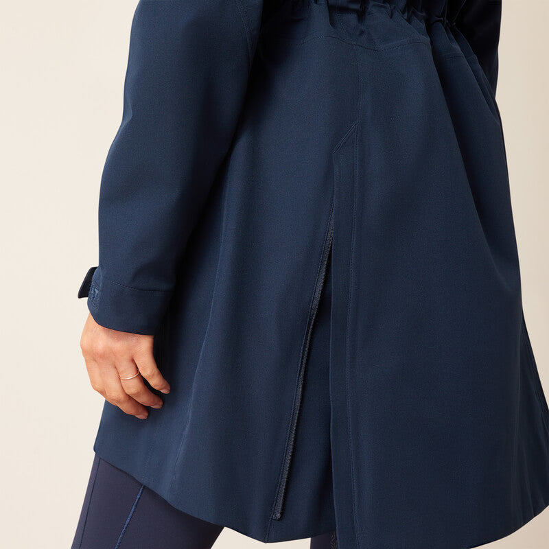 Wearing an Ariat Womens Coastal Long H2O Parka in navy, hand visible at the side slit.