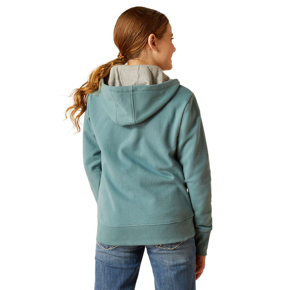 Girl with long ponytail in Ariat Youth Team Logo Hoodie North Atlantic and jeans, seen from behind.