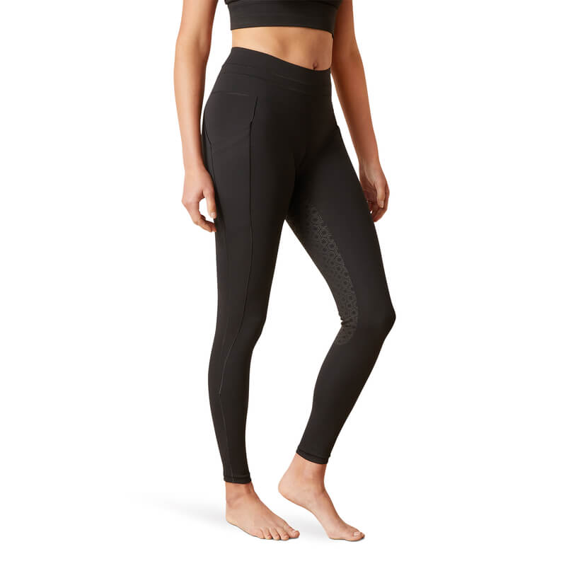 Woman wears Ariat Womens Eos 2.0 FS Tight Black leggings, standing barefoot.