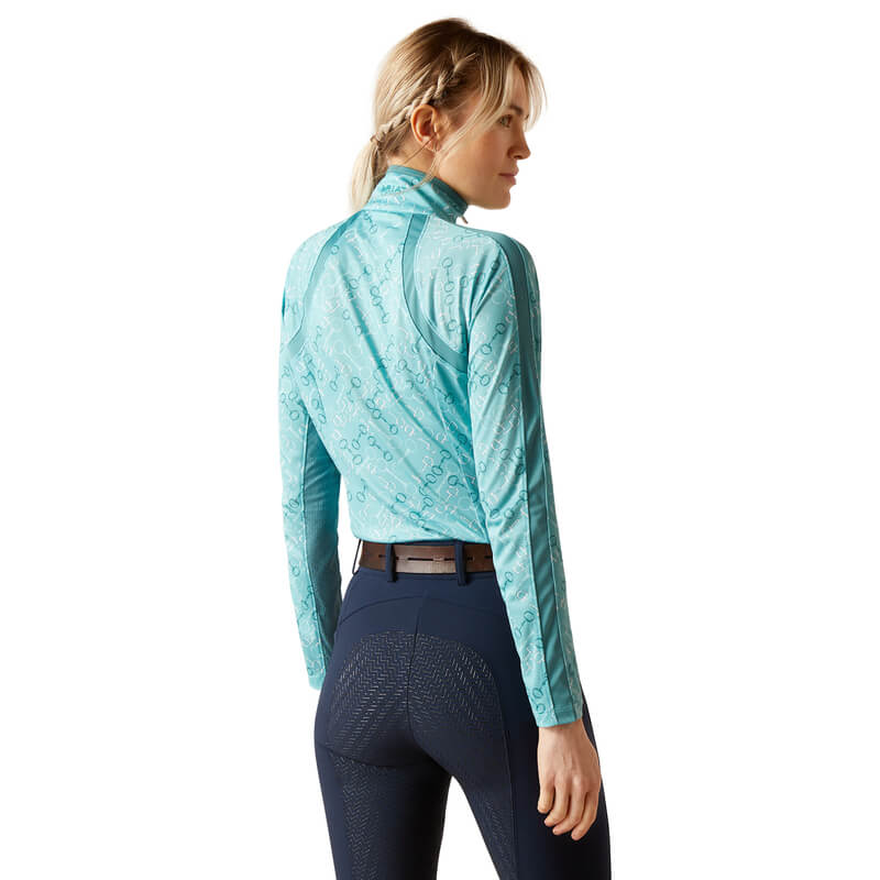 Woman in Ariat Womens Sunstopper 3.0 Baselayer Marine Blue Bit Print, standing and smiling.