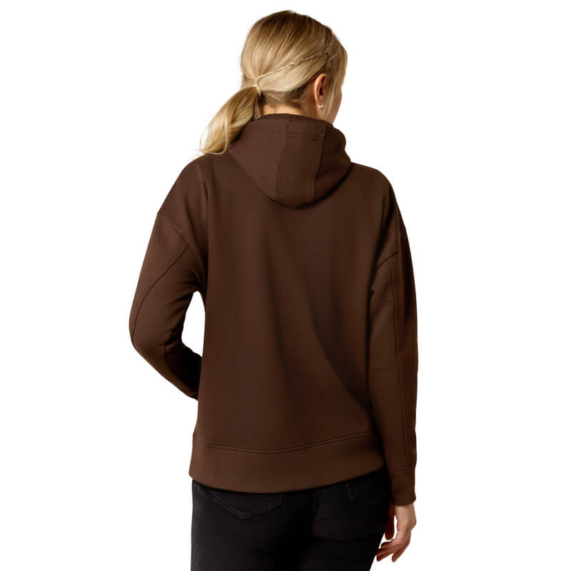 Blonde-haired person wears Ariat Womens Rabere Hoodie Mole and black pants, facing away.