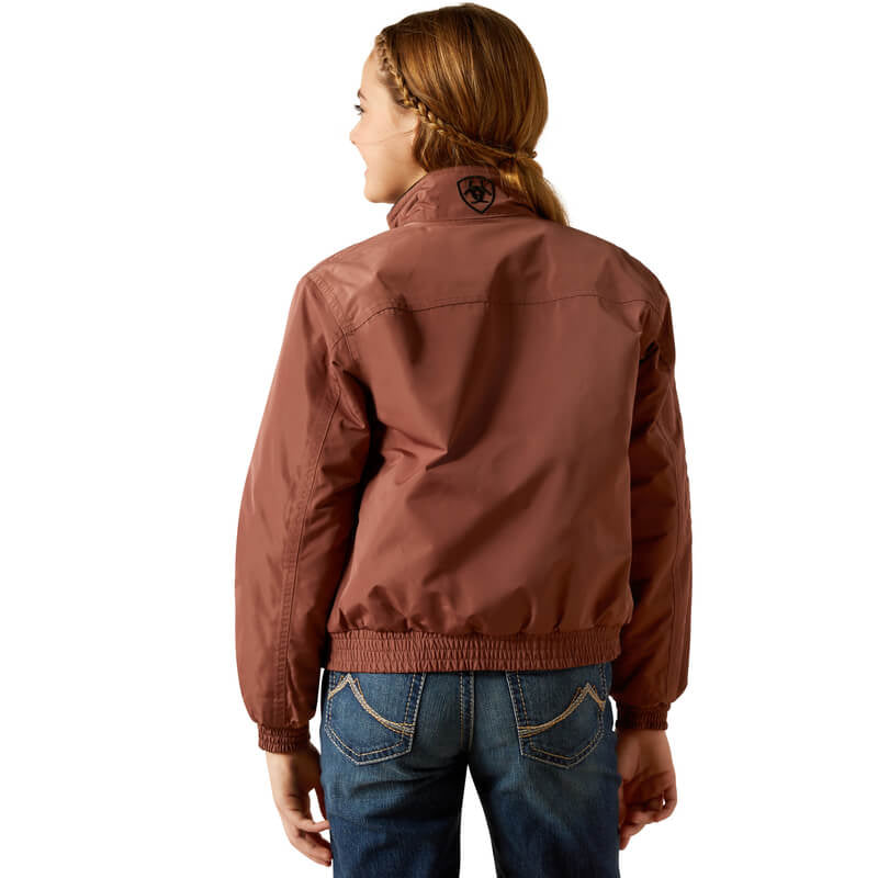 Wearing the Ariat Youth Stable Jacket Marron and jeans, facing away on a white background.