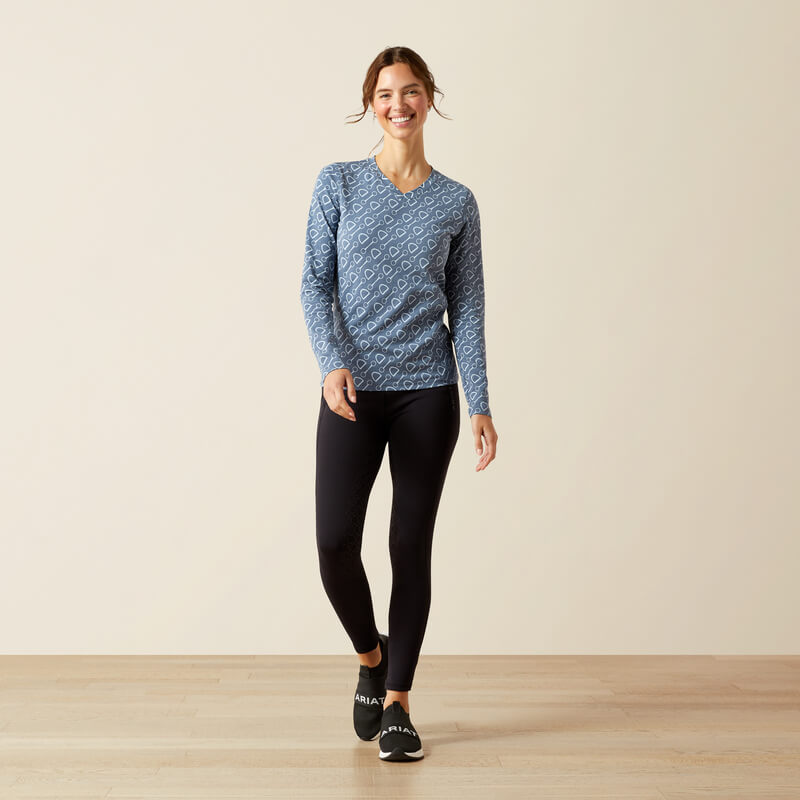 Woman in an Ariat Hardware Print Long Sleeve T-Shirt China Blue and black leggings indoors.