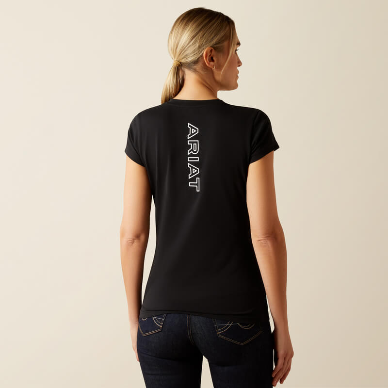 Woman in Ariat Womens BV Logo T-Shirt Black stands against a light, plain background.