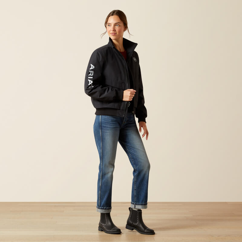 Smiling woman in an Ariat Womens Stable 2.0 Insulated Jacket Black and blue jeans.