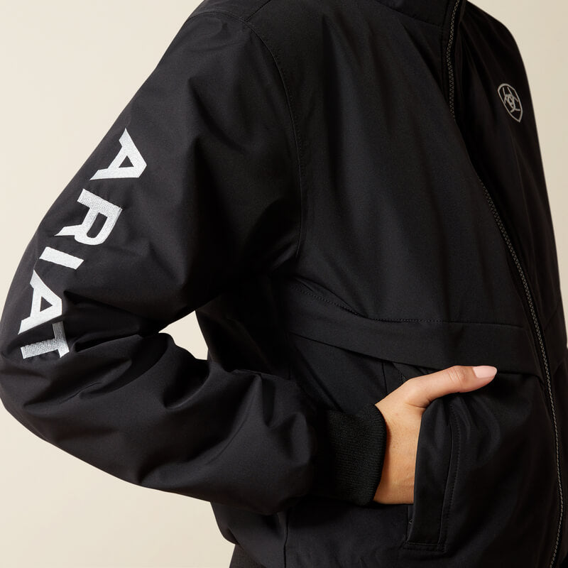 Person wearing Ariat Womens Stable 2.0 Insulated Jacket Black; Ariat logo on sleeve and chest.