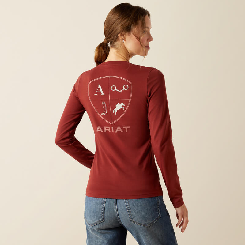 Woman in an Ariat EQ Icons Madder Brown long sleeve tee stands against a plain background.
