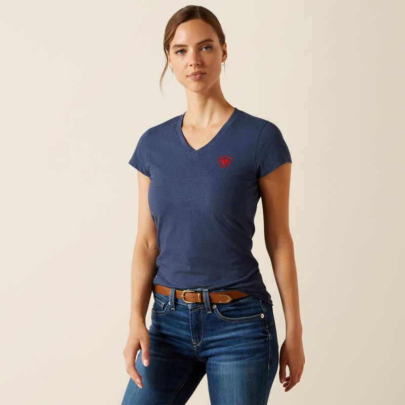 Woman wears Ariat Womens BV Logo T-Shirt Navy Heather, standing against a plain light background.