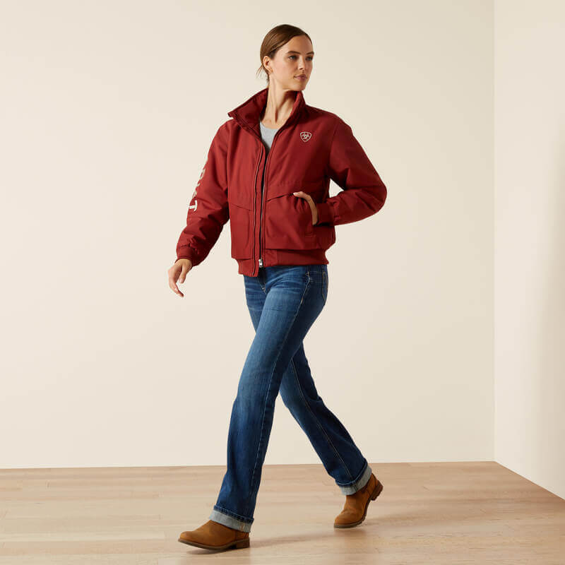 Woman wearing Ariat Womens Stable 2.0 Insulated Jacket in Madder Brown, hands near pockets.