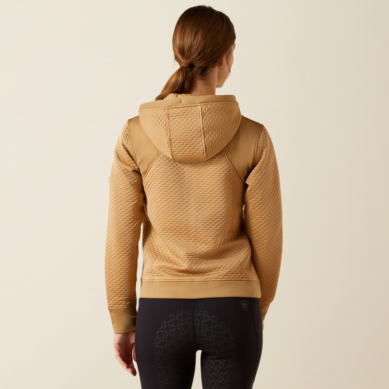 Woman in Ariat Radiance Full Zip Tiger's Eye hoodie and black leggings with moisture-wicking tech.