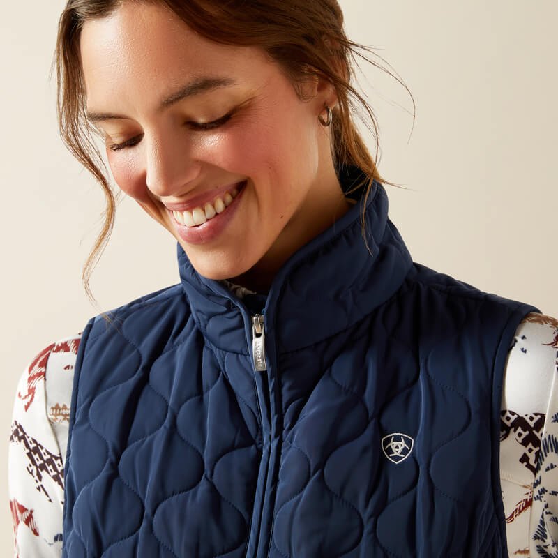Woman smiling in an Ariat Womens Ashley 2.0 Insulated Vest Big Dipper and a patterned shirt.