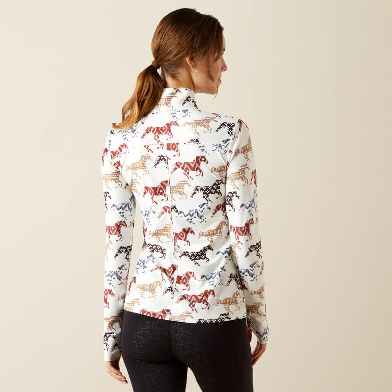 Woman in Ariat Lowell 3.0 baselayer, Painted Ponies print, faces away from camera.