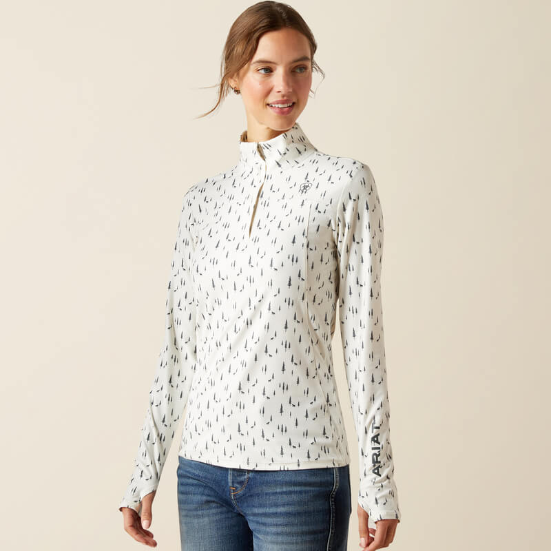 Woman in Ariat Womens Lowell 3.0 Baselayer Forest Horses Print, standing and smiling.