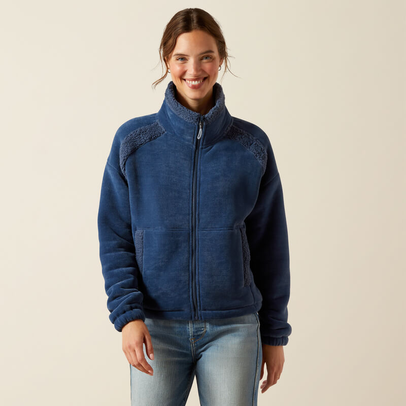 Woman in Ariat Lafayette Full Zip Fleece Big Dipper and jeans, smiling at the camera.