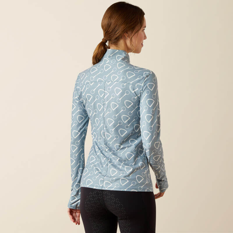 Woman in Ariat Womens Lowell 3.0 1/4 Zip Baselayer Hardware Print and black leggings.