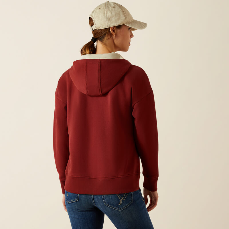 Woman in an Ariat Womens Rabere 2.0 Hoodie Madder Brown and beige cap, back to camera.